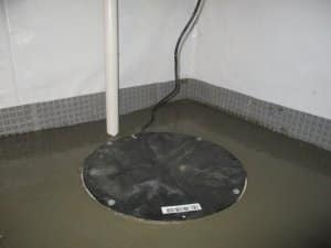 Sump pump in a flooded basement, illustrating the importance of sump pumps in preventing water damage and maintaining a dry environment.