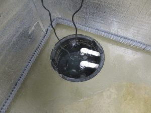 Sump pump system installed in basement in Hamilton NJ removing water and preventing flooding