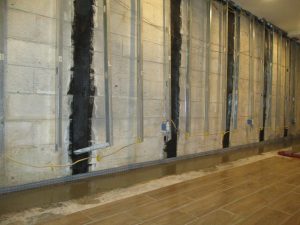 Carbon fiber straps installed on basement wall to repair cracks and prevent bowing