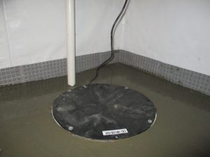 Sealed sump pump pit with interior drainage system installed in a basement in Jersey City PA