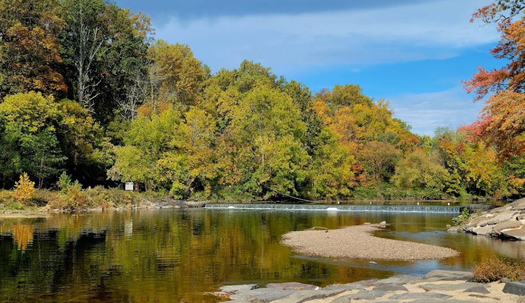 Scenic view of a river surrounded by autumn foliage in Richboro, PA, highlighting the natural beauty relevant to Aqua Dry Basement Waterproofing's services.
